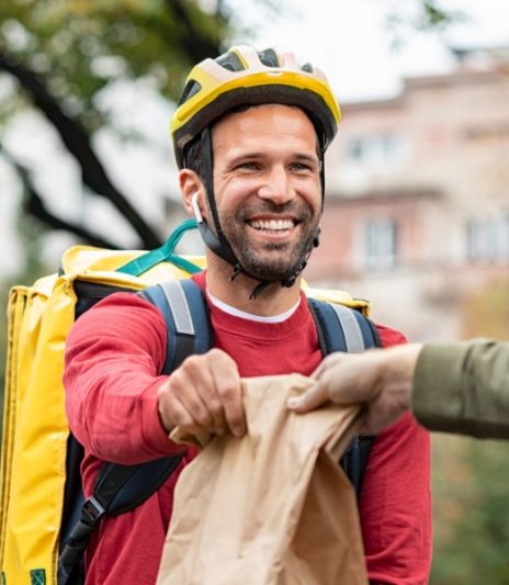 delivery-man-giving-take-away-food-DBXUQTG.jpg